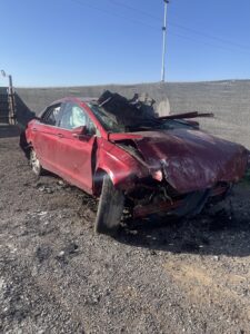Why I Believe in Miracle: Banged up red car