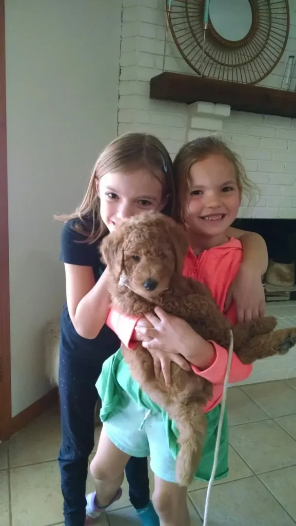 Two girl with brown puppy